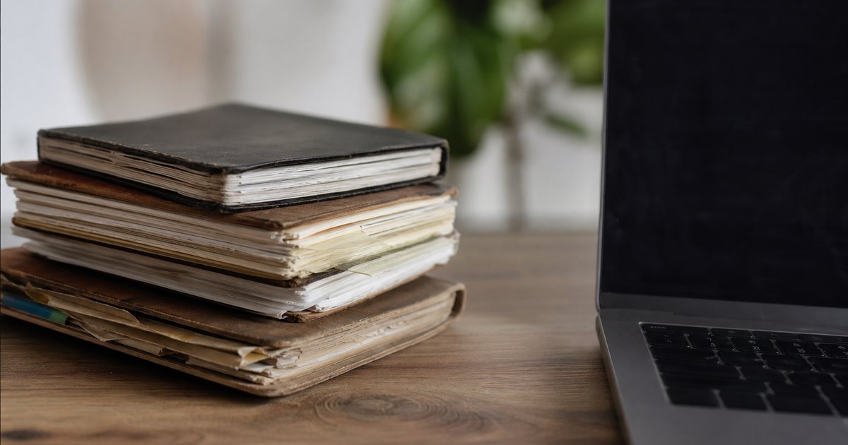 When should a coach move client notes from a paper notebook into a dedicated coaching ledger?